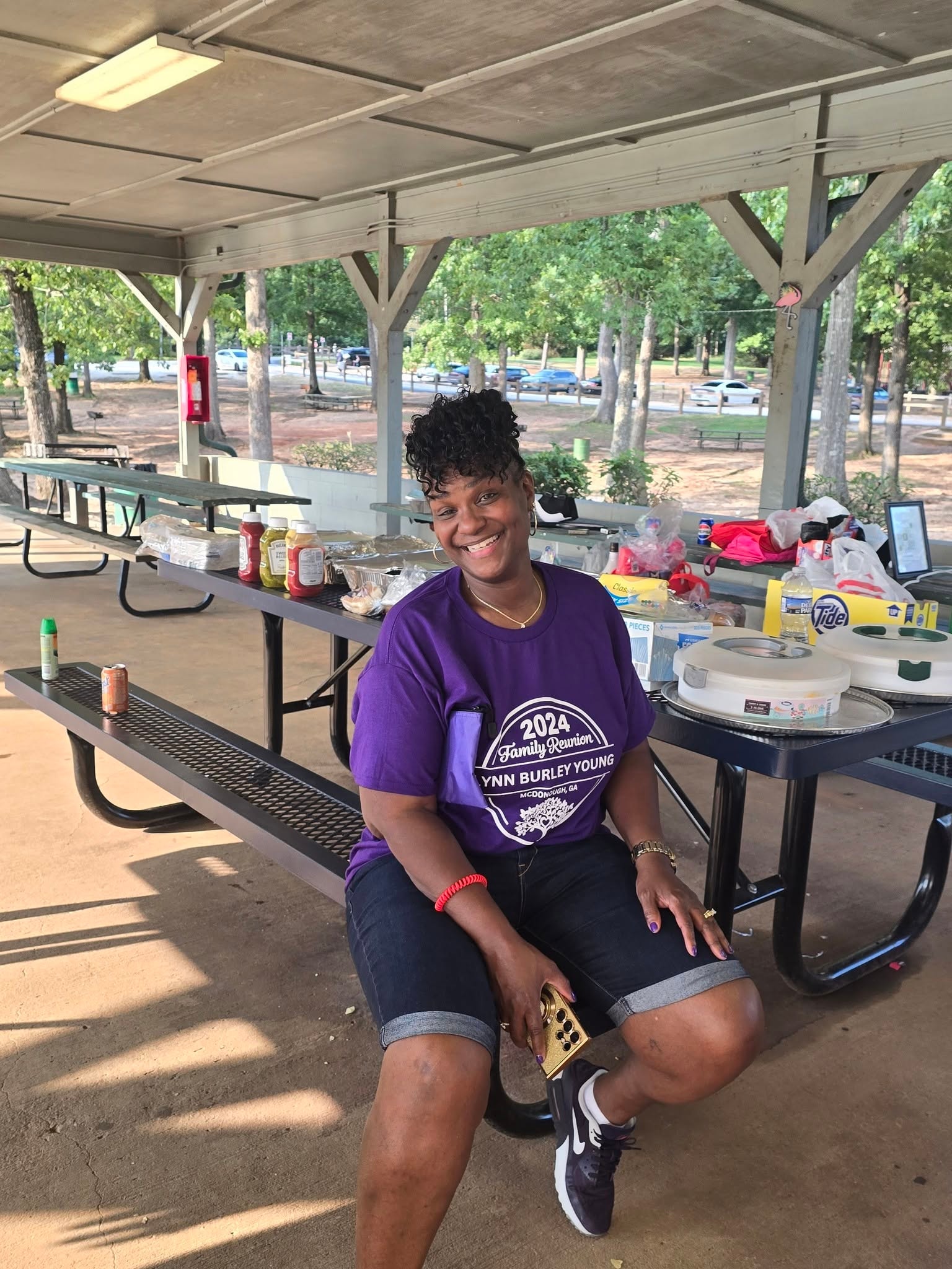 Family member smiling at reunion cookout pavilion