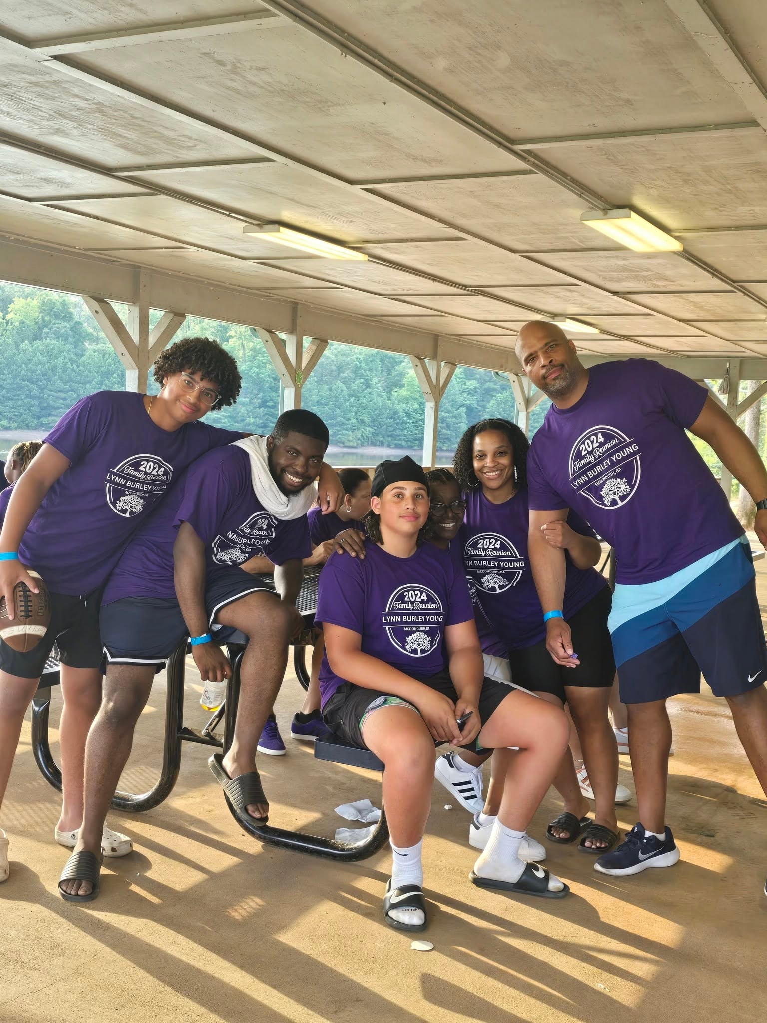 Group of family members in purple reunion shirts