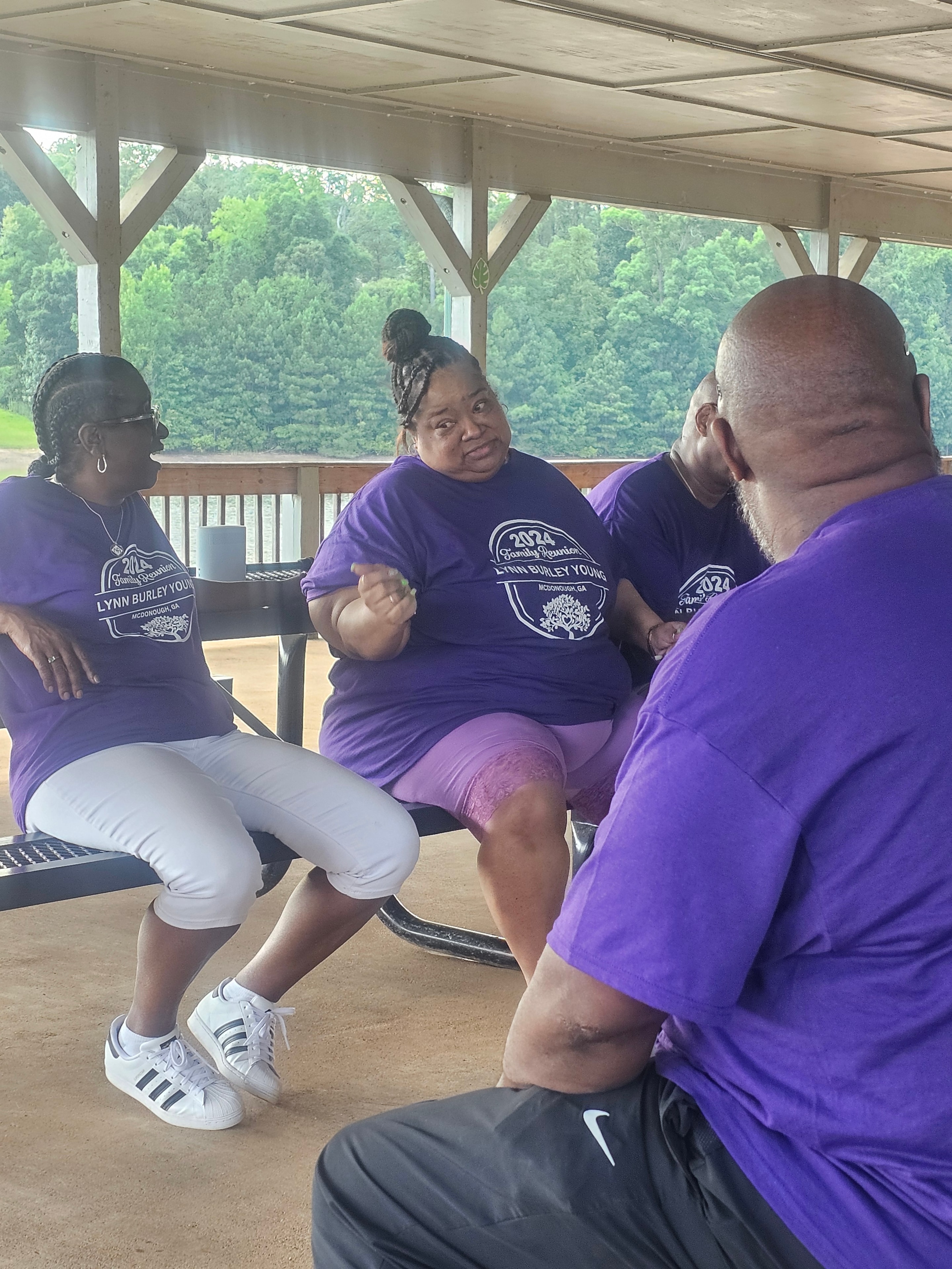 Family members in Lynn-Burley-Young reunion shirts at outdoor gathering with balloons
