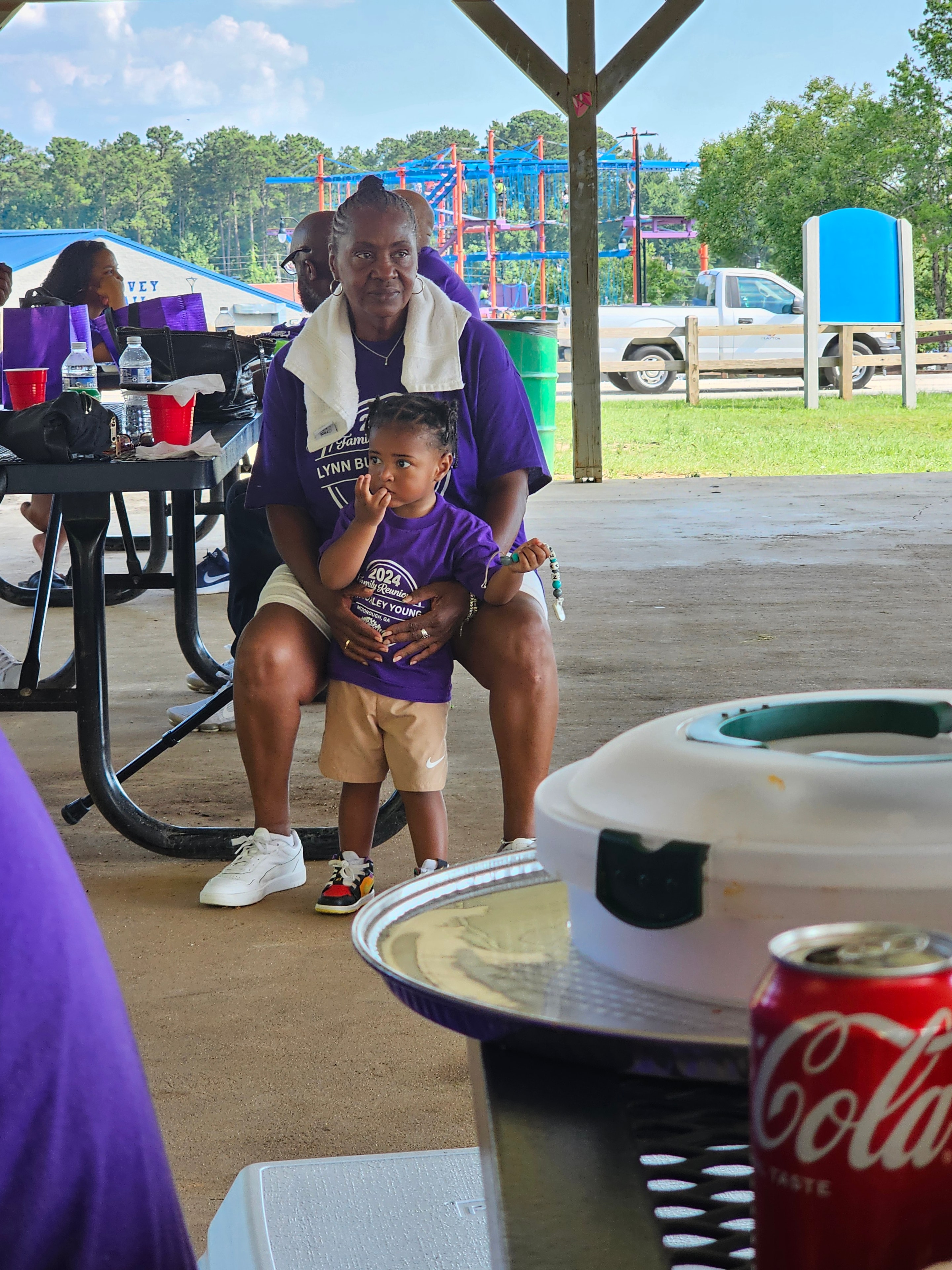 Two family members in Lynn-Burley-Young Atlanta reunion shirts outside venue