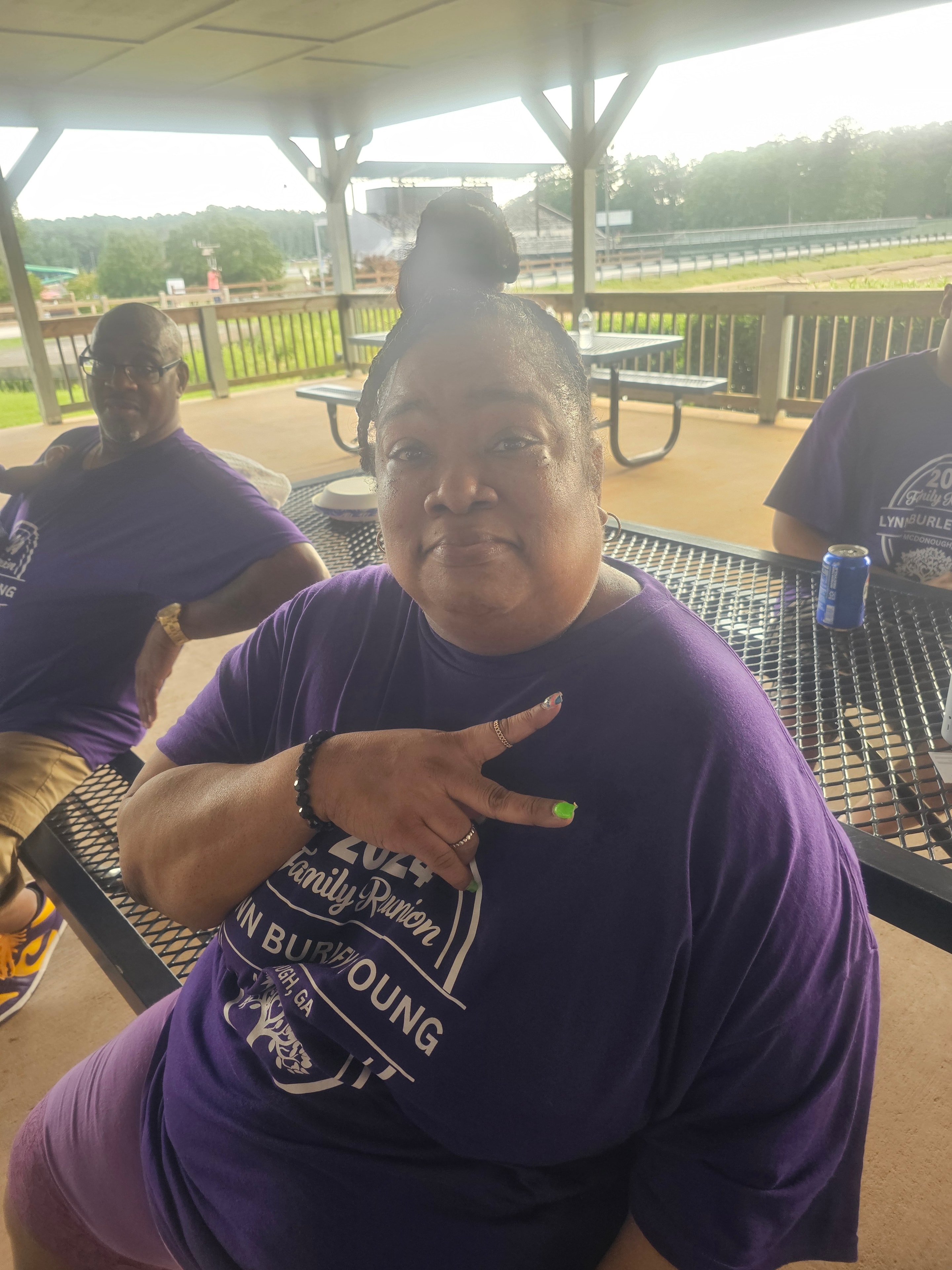 Three family members in Lynn-Burley-Young Atlanta reunion shirts outside venue