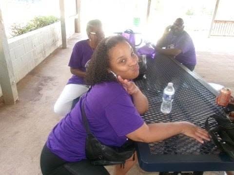 Couple in 2024 Lynn Burley Young reunion shirts smiling at pavilion